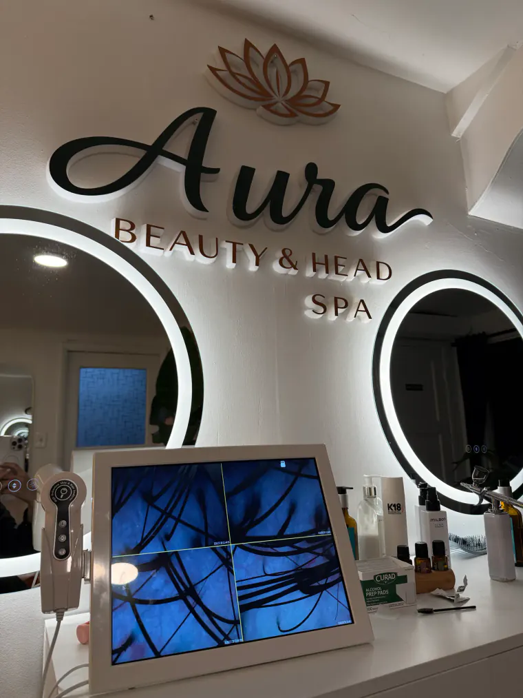 The scalp camera and monitor at Aura in Issaquah showing hair follicles magnified at the start of a head spa